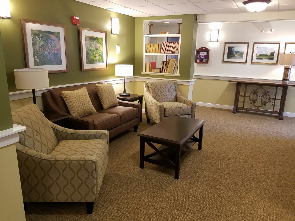 A cozy living room with a sofa, armchairs, and a coffee table.