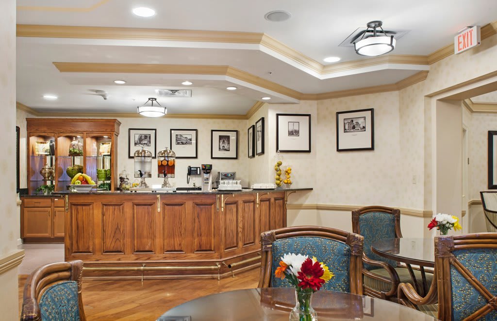 A cozy cafe interior with wooden furniture and framed pictures on the walls.