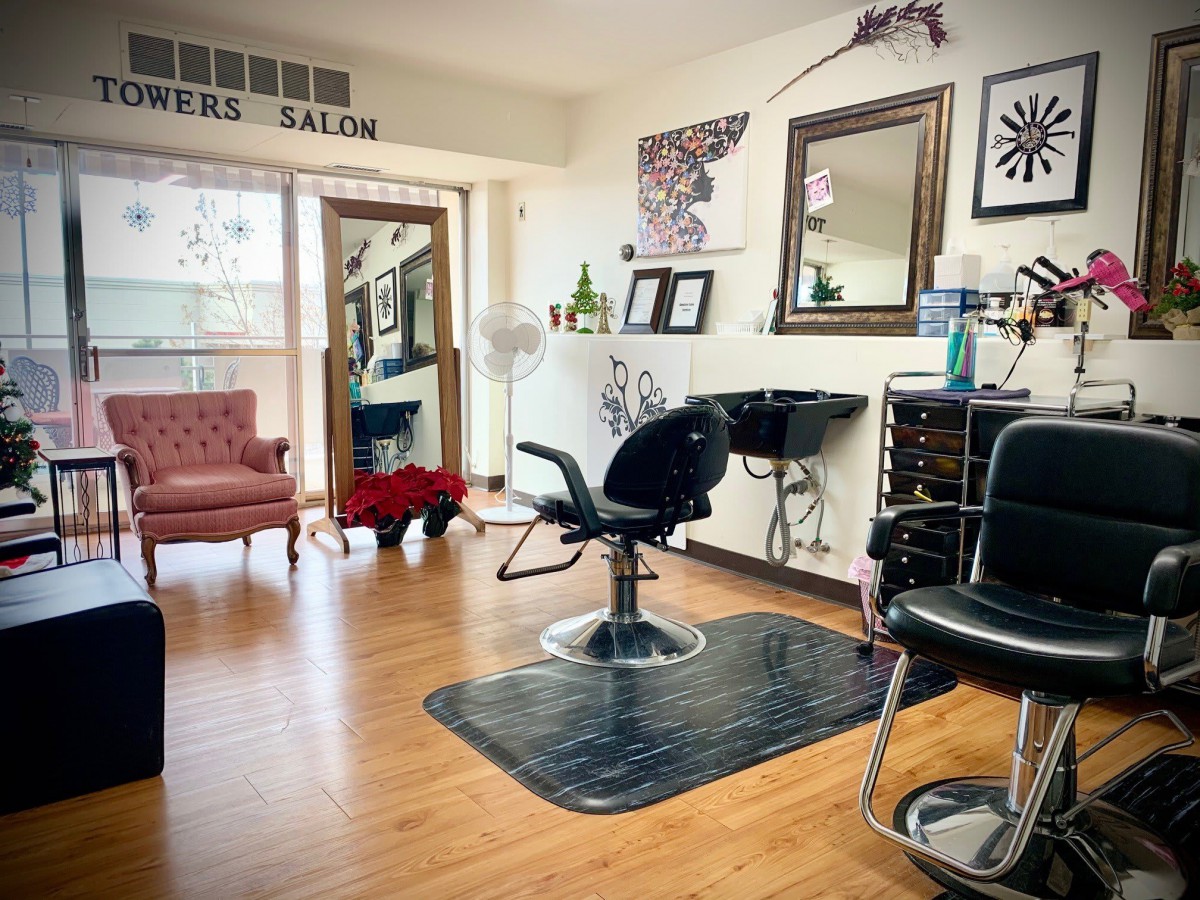 Interior view of a hair salon with stylist chairs and mirrors.