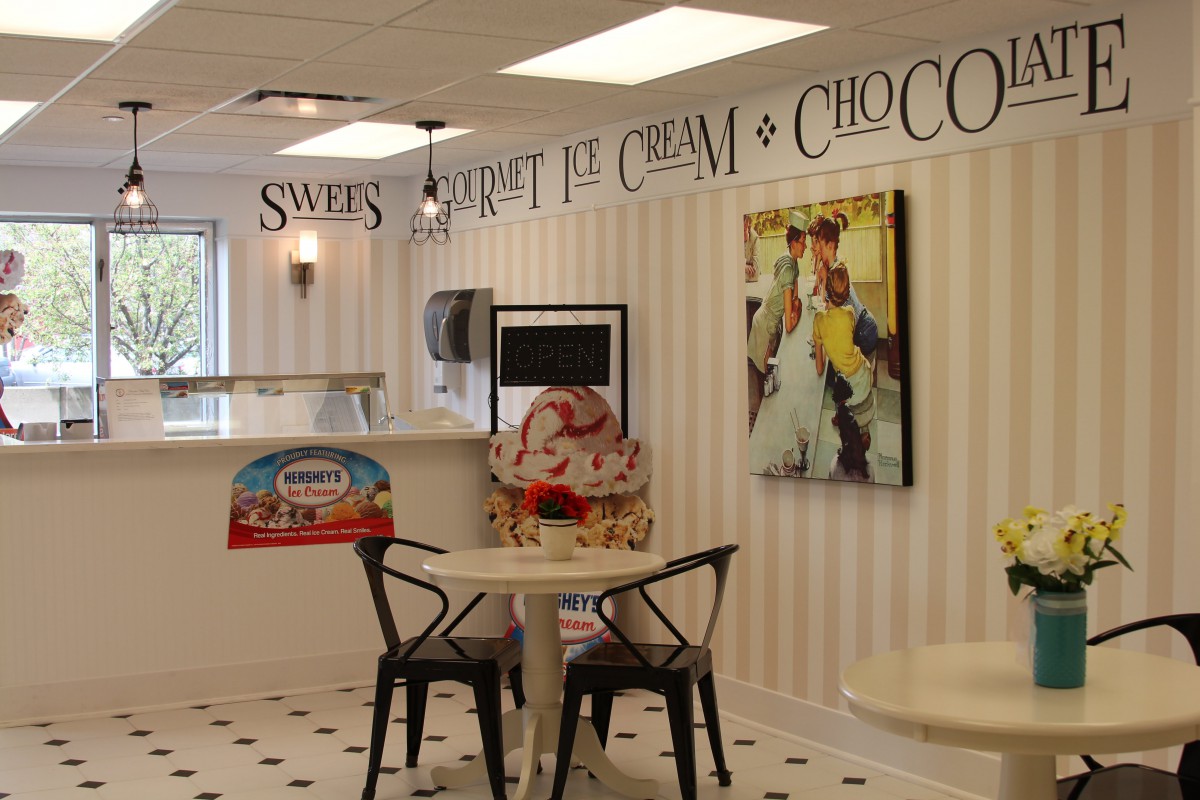 A cozy ice cream shop interior with vintage decor and seating.