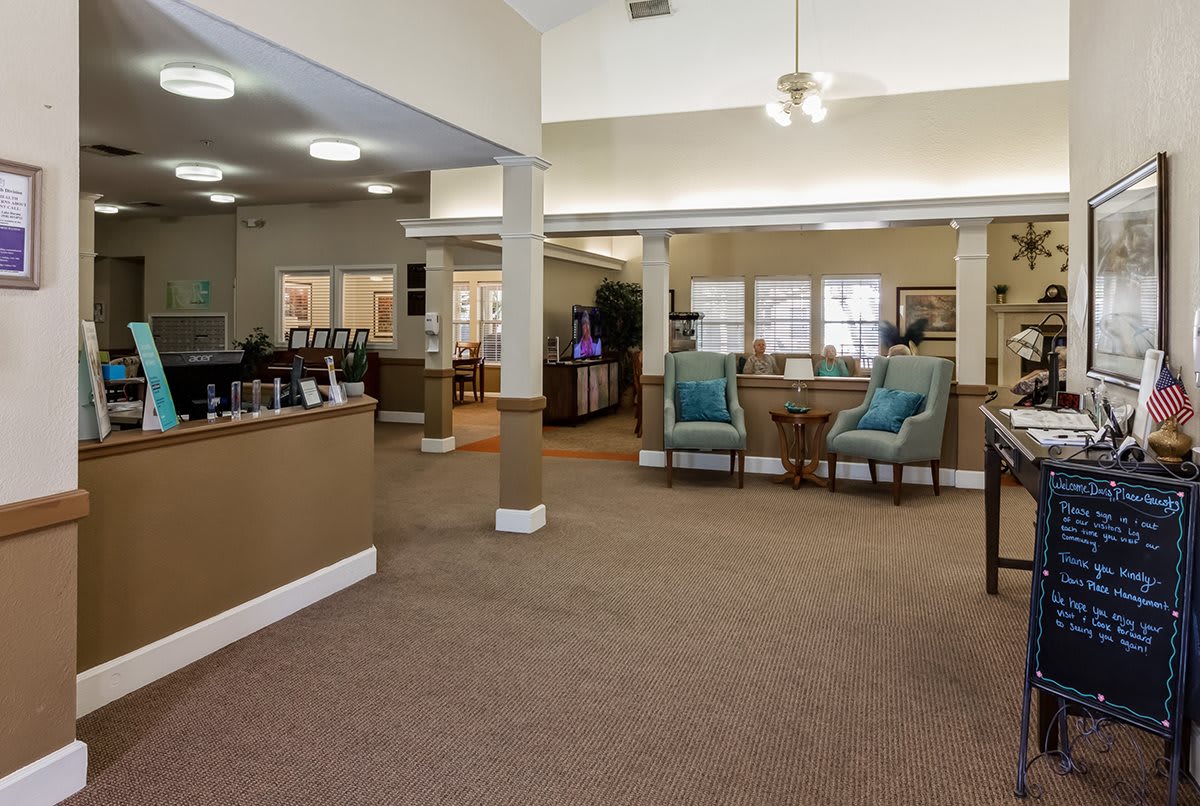 A spacious office interior with a waiting area featuring chairs and tables.