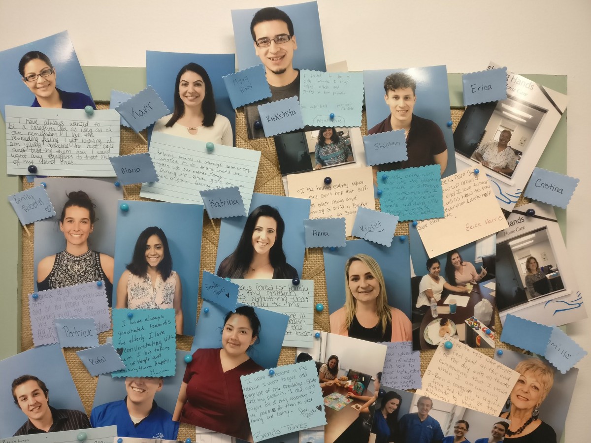 A bulletin board displaying a collage of portraits and handwritten notes.