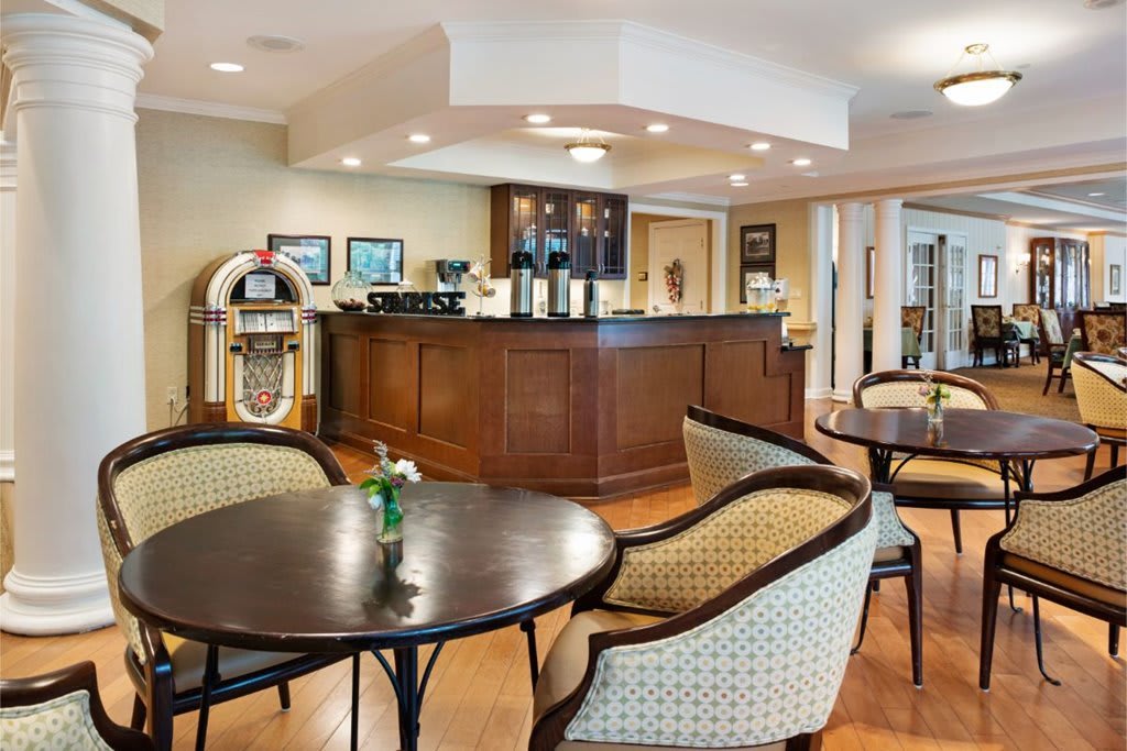 A cozy cafe interior with comfortable seating and a jukebox.