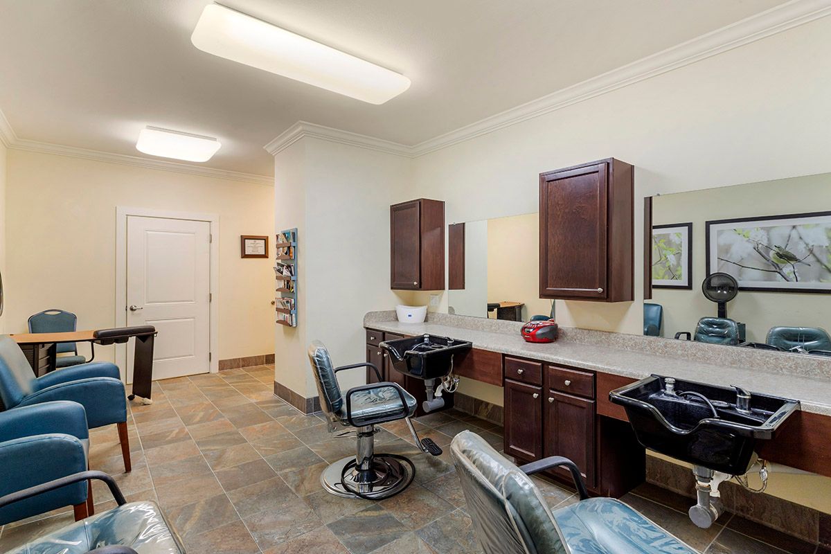Modern hair salon interior with chairs, mirrors, and wooden cabinets.