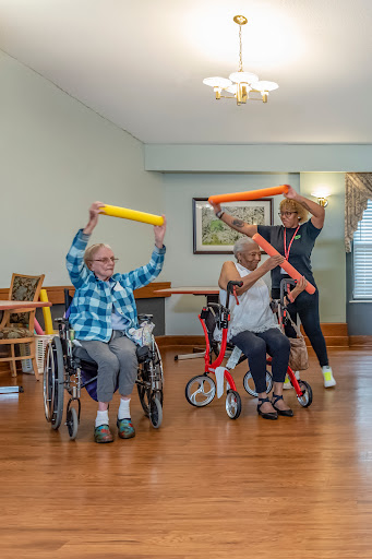 Seniors engaging in a fun exercise class using foam rollers for physical activity and rehabilitation.