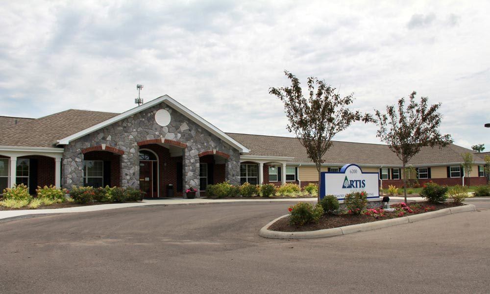 Exterior view of a nursing home with a welcoming entrance and well-maintained landscaping.