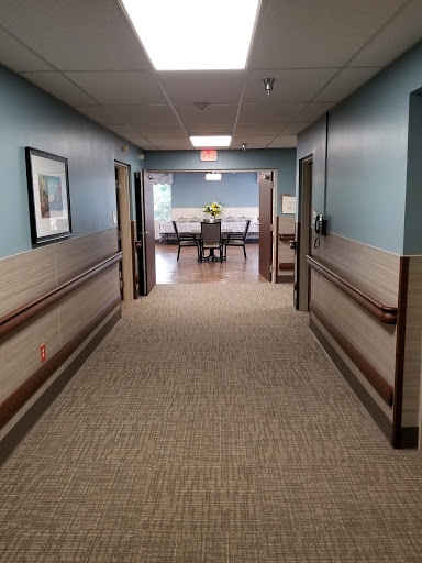 A view of a well-lit hallway leading to a waiting area in a healthcare facility.