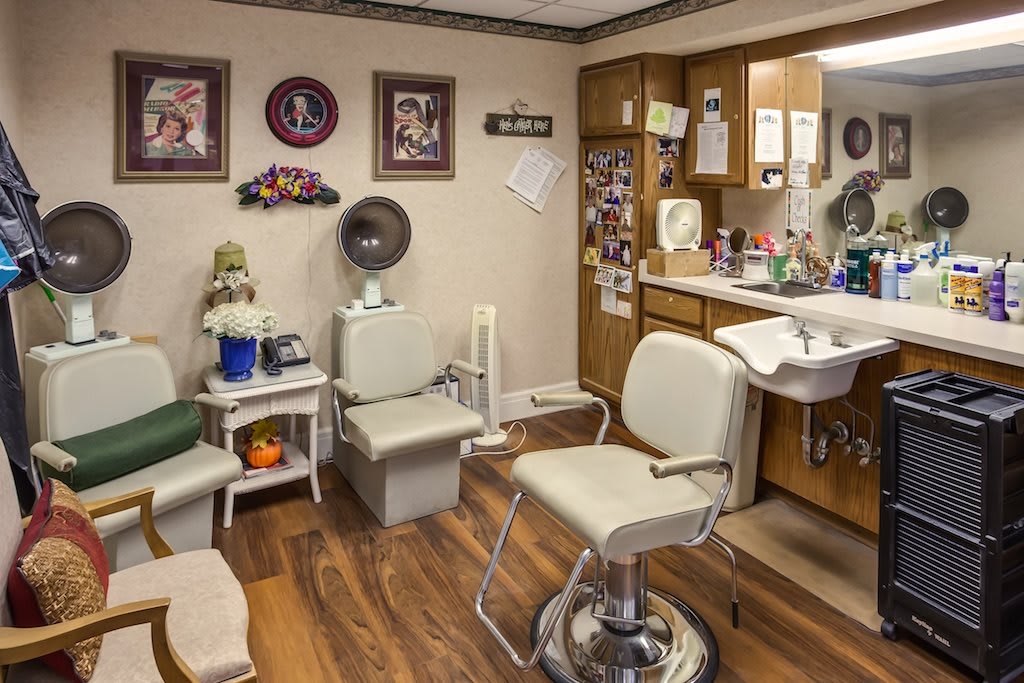 Cozy and vintage barber shop interior with chairs, mirrors, and hair styling tools.