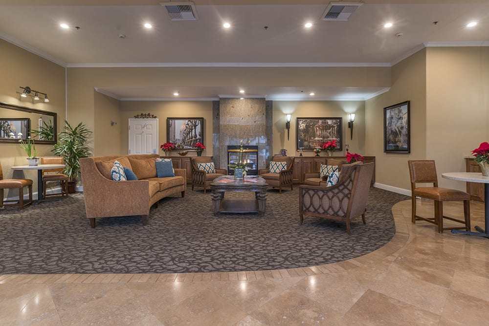 A cozy and elegantly decorated lobby with comfortable seating and a fireplace.