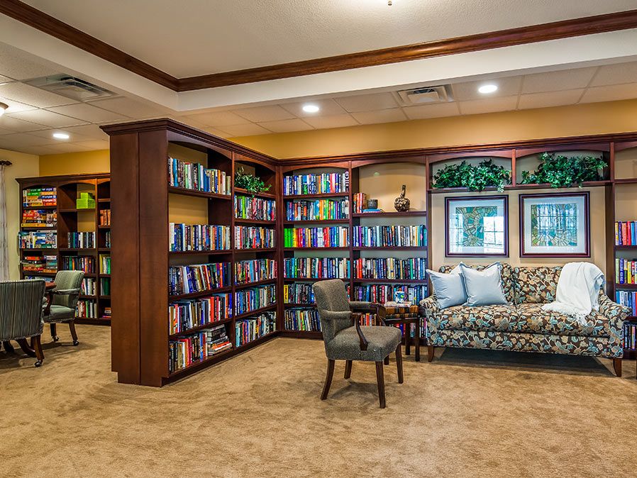 A cozy library nook with bookshelves, comfortable seating, and a warm atmosphere.