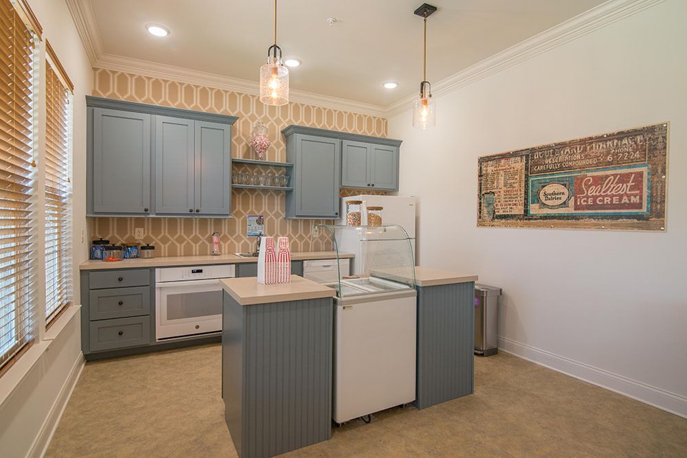 A cozy kitchen featuring blue cabinets, modern appliances, and a central island.