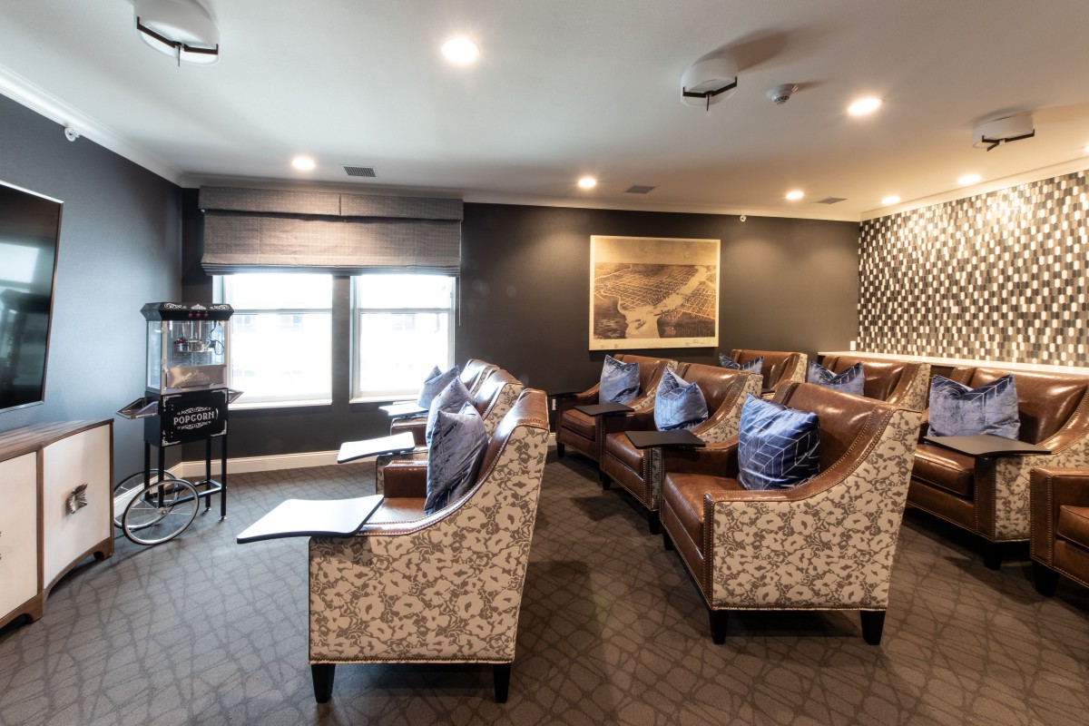 A cozy living room with comfortable seating and a home theater setup.