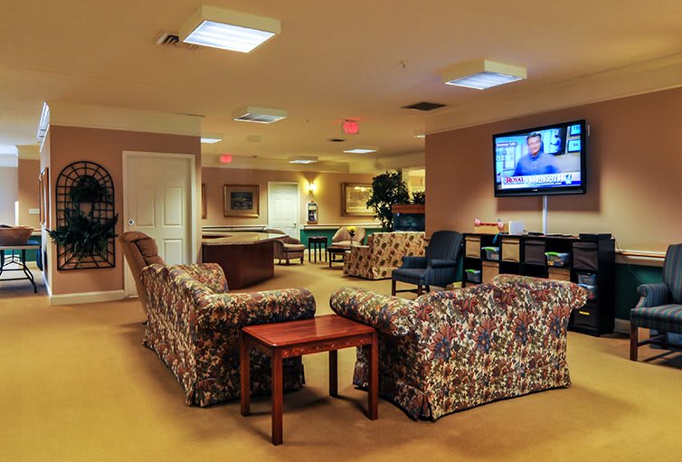 A cozy lounge with comfortable seating and a television.