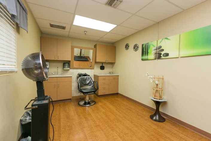 A well-organized hair salon with modern decor and a comfortable styling chair.