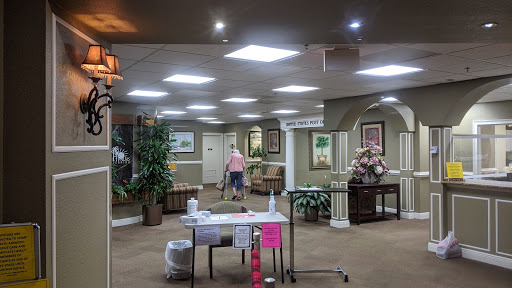 A spacious and well-decorated lobby area with bright lighting and plants.