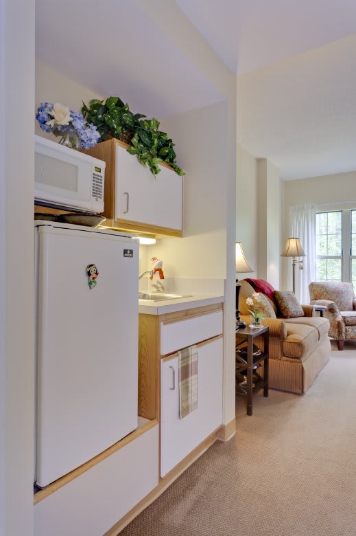 A cozy apartment with a small kitchenette and a comfortable living area.
