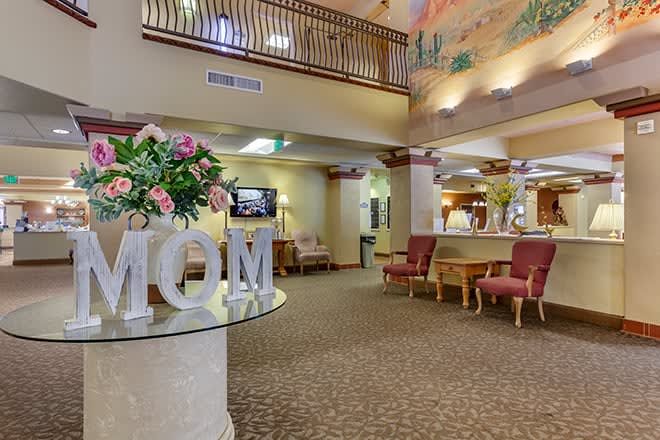 A well-decorated lobby with comfortable seating and floral arrangements.