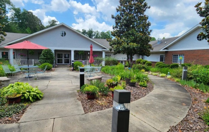 A well-maintained garden area with pathways and benches outside a building.
