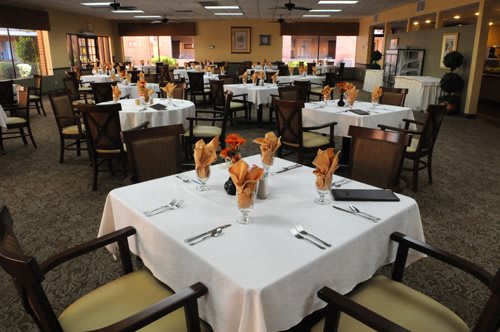 A neatly arranged restaurant dining area with tables set for guests.