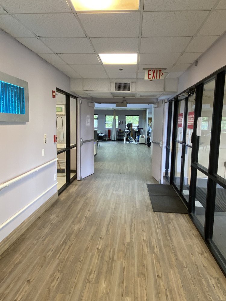 A view down a hallway with glass doors at the entrance.