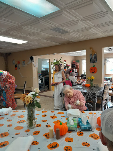Residents engaging in activities at a community center, decorated for autumn.