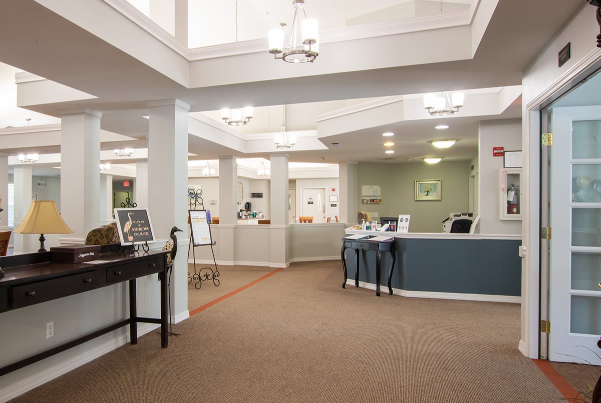 A spacious and well-lit lobby area with a reception desk and decorative elements.