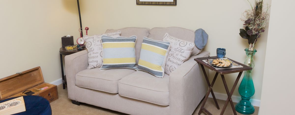 A cozy living room sofa adorned with patterned and striped cushions.