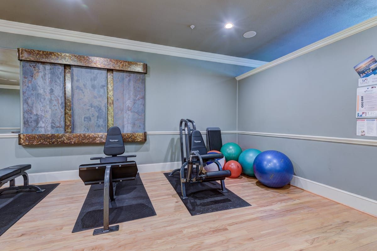 A small home gym with fitness equipment and exercise balls.