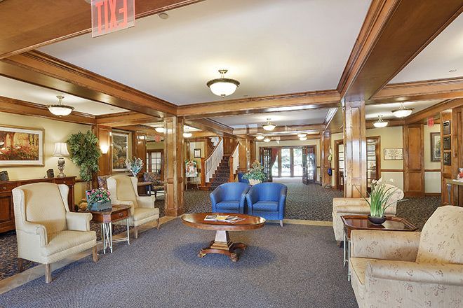 A spacious and elegantly decorated lobby with comfortable seating and classical wooden accents.