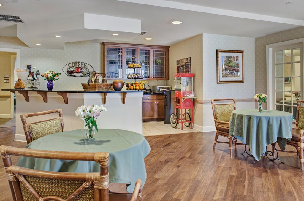 A cozy cafe interior with tables, chairs, and decorative elements.