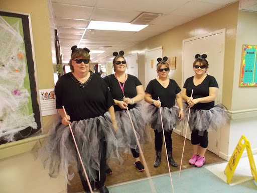 A fun and creative group dressed in ballet-themed costumes, complete with tutus and sunglasses.