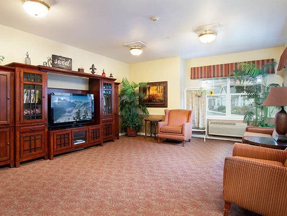 A cozy living room with comfortable seating and a large television.