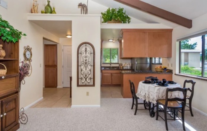 A cozy home interior featuring a kitchen and dining area in an open space layout.