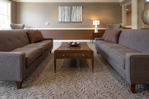 A cozy living room setup featuring two sofas, a wooden coffee table, and ambient lighting.