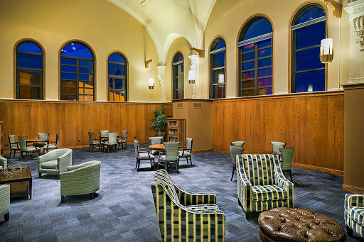 A cozy lounge area featuring stylish seating arrangements and warm architectural details.
