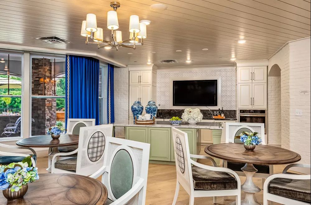 A modern kitchen and dining area with elegant decor and bright lighting.
