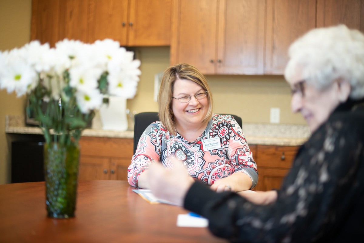 Two people having a conversation in an office setting.