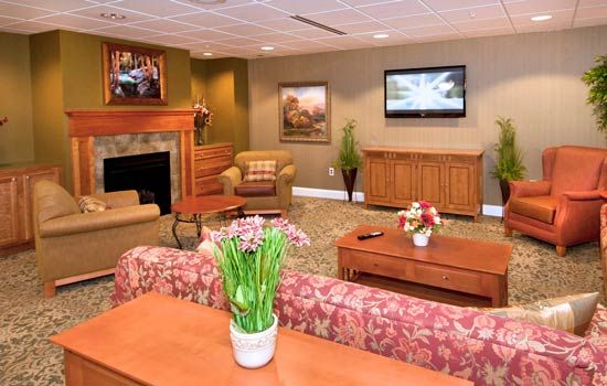 Cozy living room with a fireplace, television, and comfortable seating.