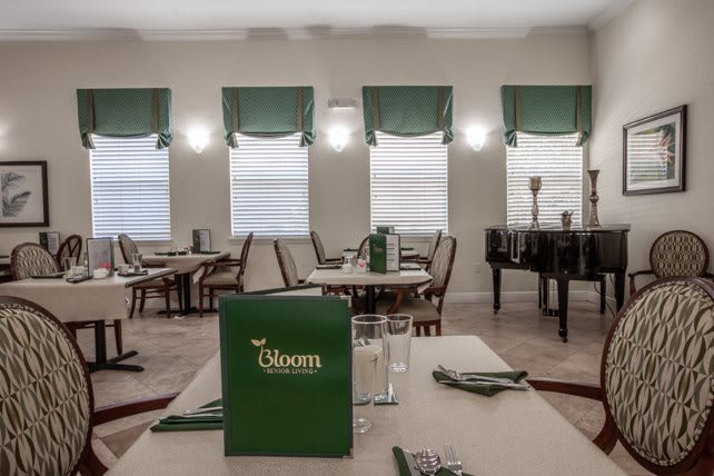 An elegant restaurant interior with neatly arranged tables and chairs.