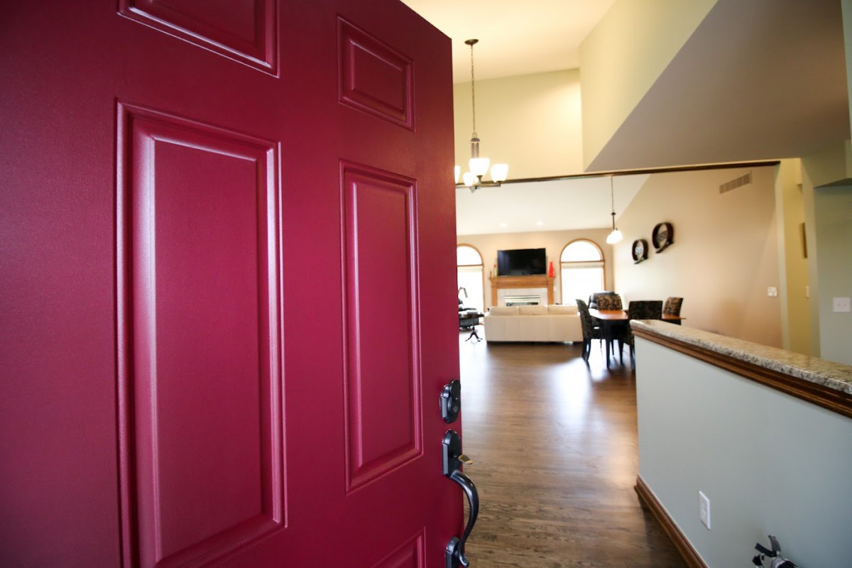 A welcoming entrance with a red door leading into a cozy living space.