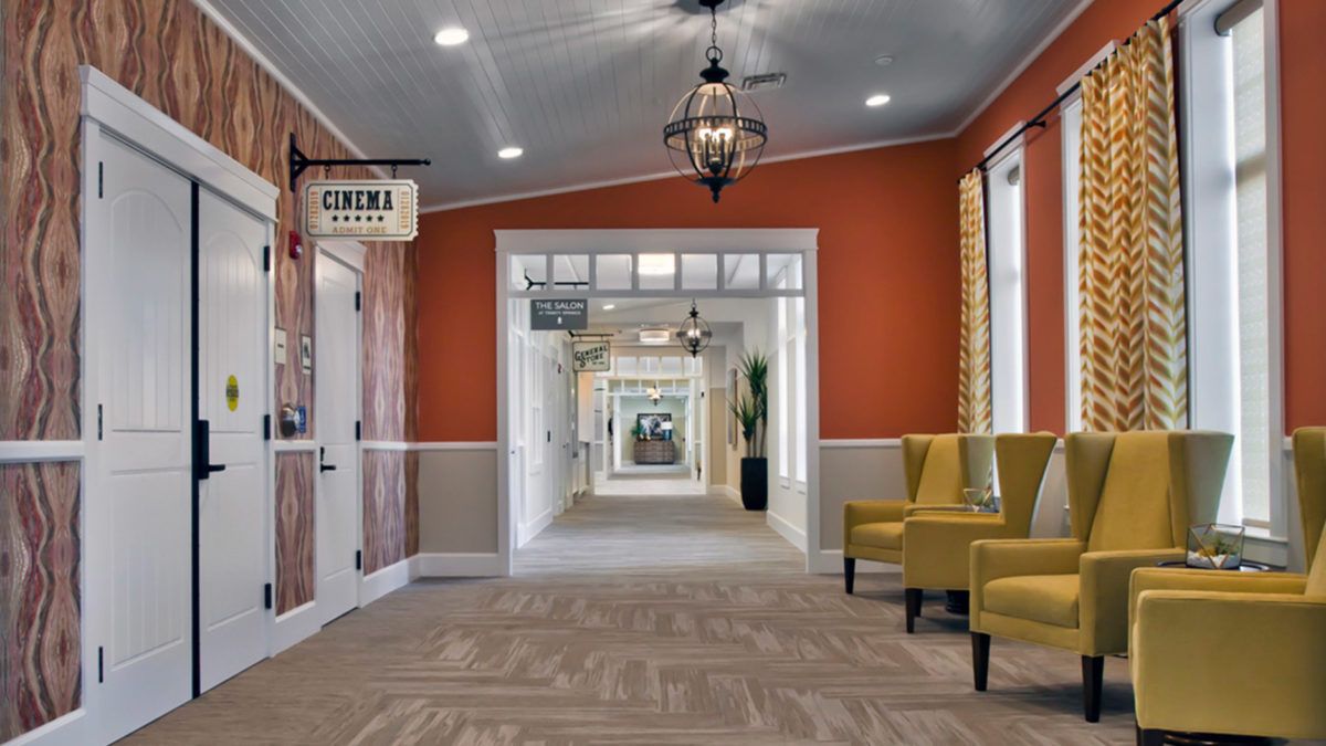 A well-decorated hallway with seating and ceiling lights.