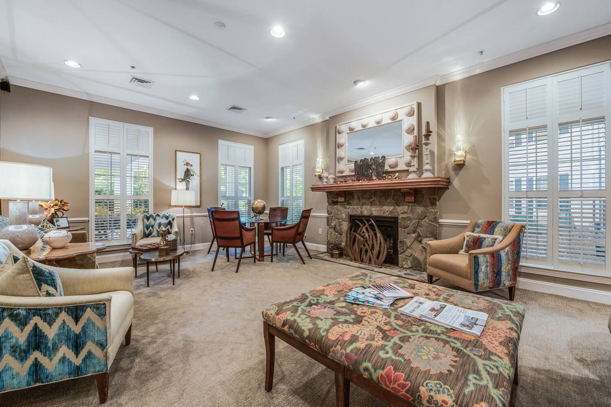 A cozy living room with a fireplace, comfortable seating, and elegant decor.
