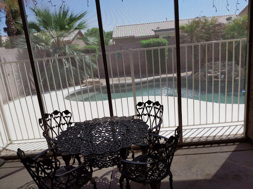 A serene patio view overlooking a pool, perfect for relaxation.