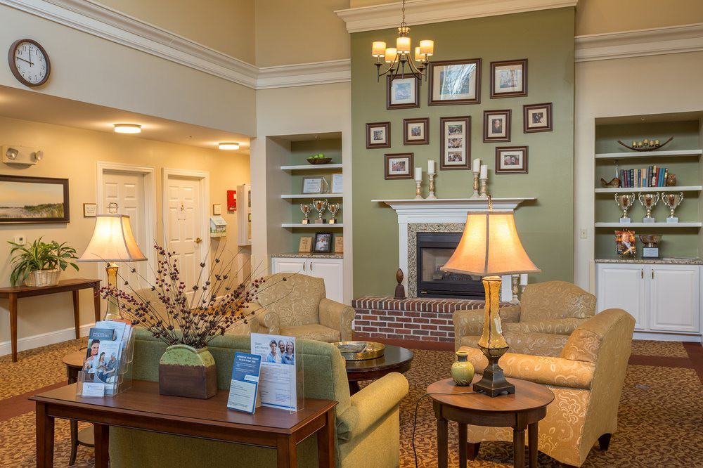 A cozy living room with elegant interior design featuring a fireplace, sofas, and decorative lamps.