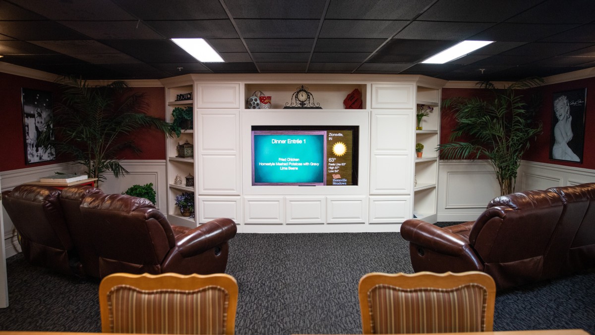 Cozy home theater setup with comfortable seating and built-in shelving.