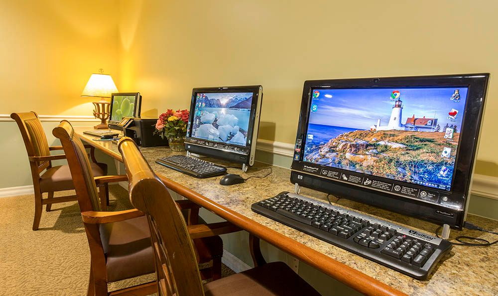 A well-organized office space with multiple computers on a desk.