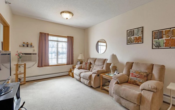 Cozy living room with comfortable sofas and warm decor.