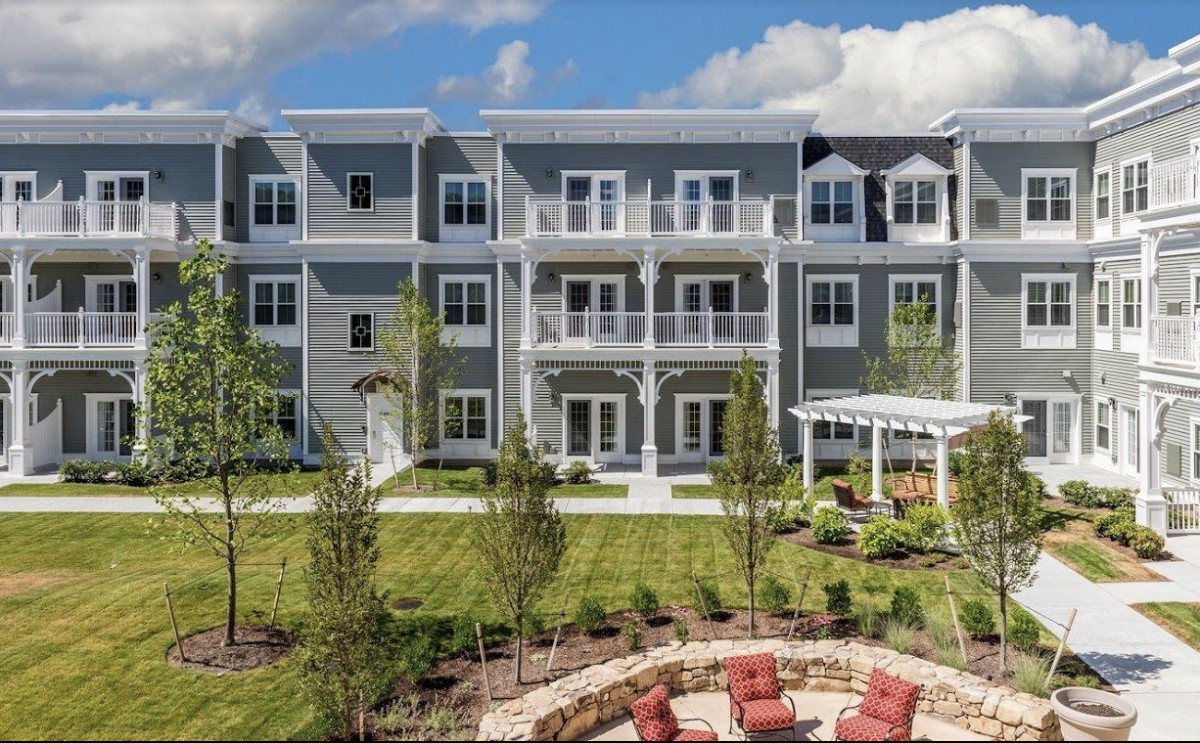 A modern apartment building with landscaped outdoor space and balconies.