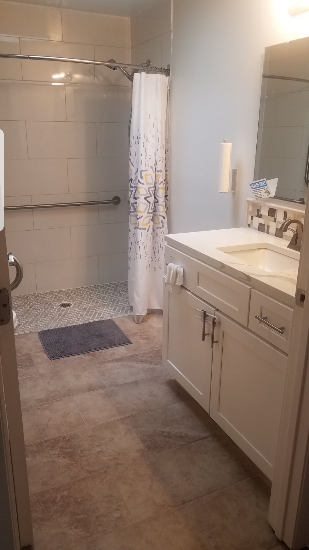 A clean and modern bathroom with a shower and sink.