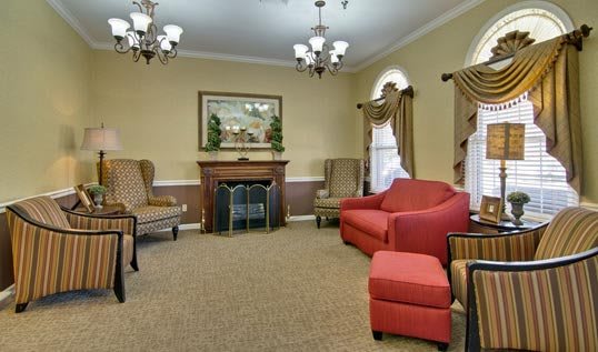 A cozy living room with comfortable seating and a fireplace.